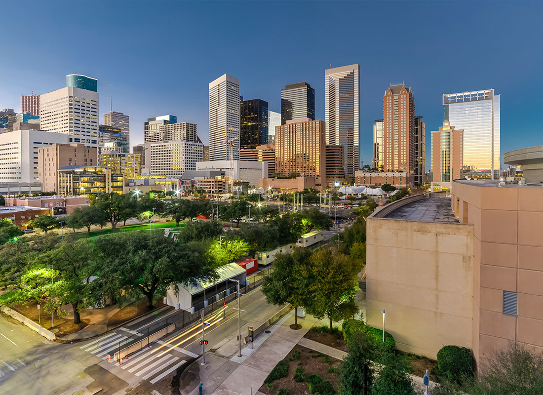 Houston, TX - Aerial View of Downtown Houston, Texas at Twilight With a Green City Park and Modern Skylines in the Background