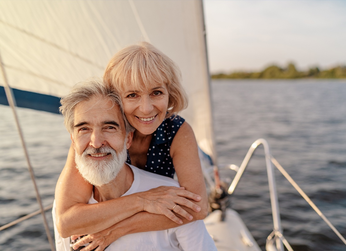 Medicare - Senior Loving Couple Sitting on the Yacht Deck While Sailing the Sea
