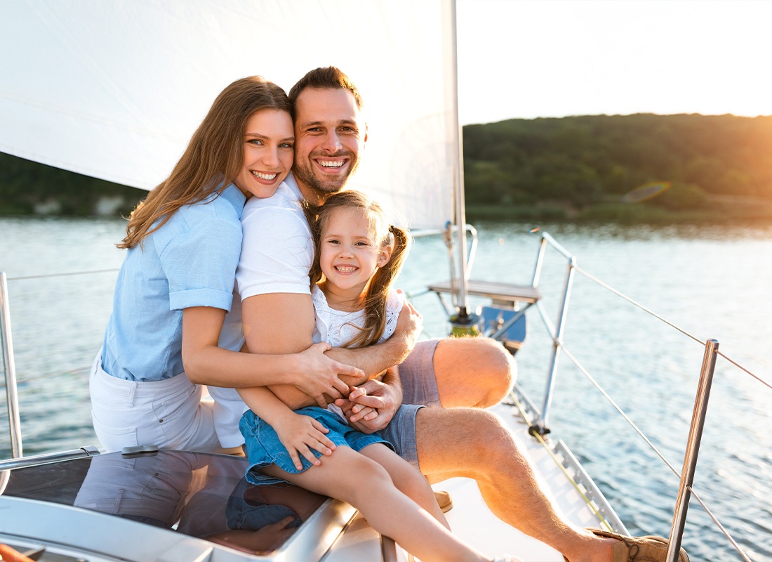 Personal Insurance - Family Sitting on Yacht Embracing and Enjoying Sea Travel Outdoors